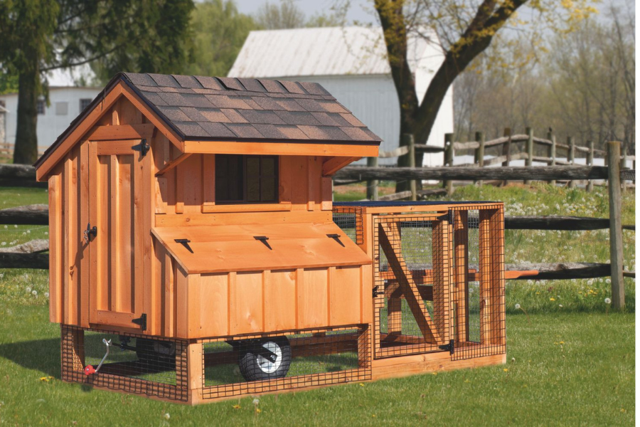 wooden tractor chicken coop by fence in Macon Georgia