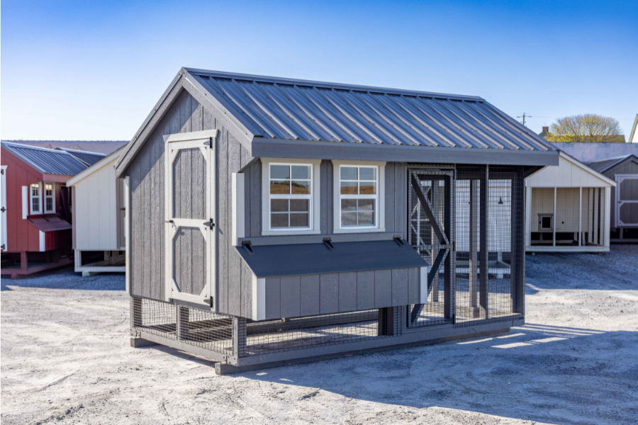 gray and white trimmed chicken coop with metal roofing