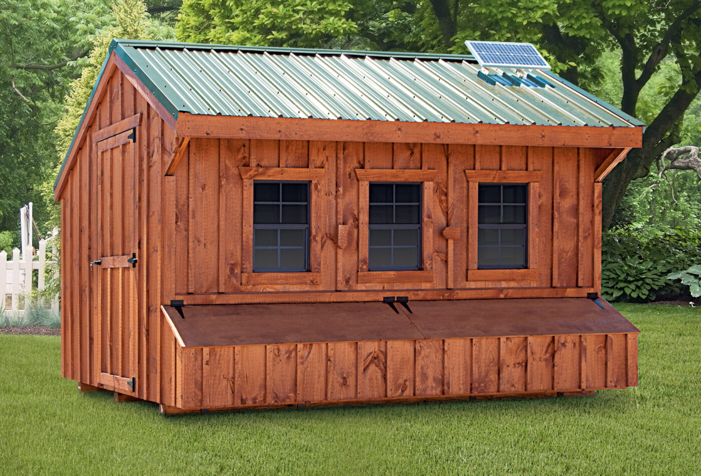 wooden chicken coops in Charlotte Hall MD with green metal roof three windows and egg collection box below them
